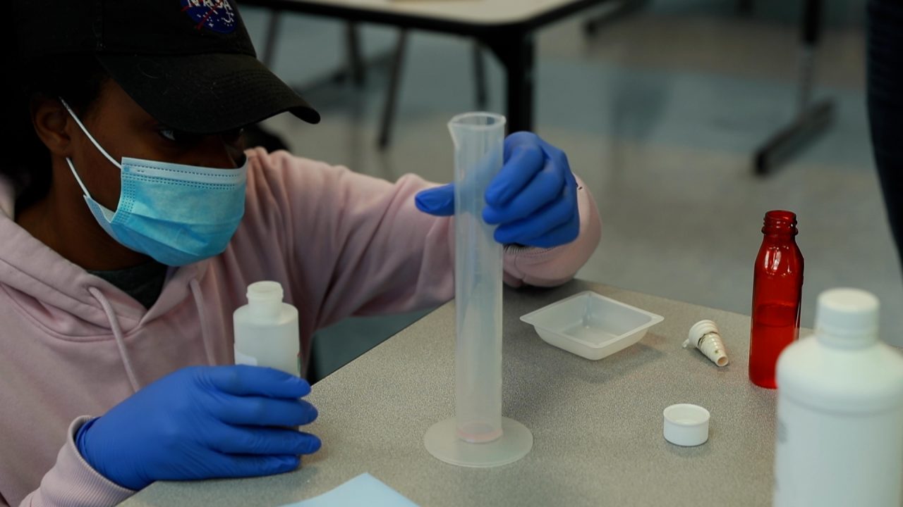 pharm tech student measuring medication